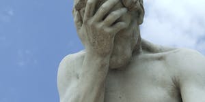 A dramatic close-up of a renowned statue in Paris expressing frustration.