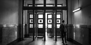 Man walking through historic doorways in Moscow. Black and white photo.